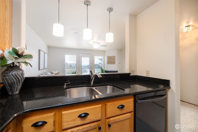 kitchen featuring sink, ceiling fan, dark stone countertops, carpet flooring, and black dishwasher