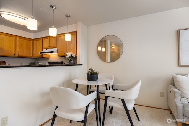 dining space with light colored carpet