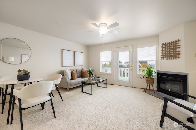 living room featuring light colored carpet and ceiling fan