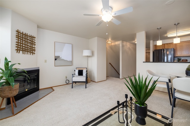 interior space featuring ceiling fan and light colored carpet