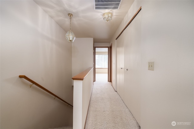 corridor with light colored carpet