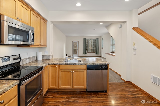 kitchen with kitchen peninsula, appliances with stainless steel finishes, dark hardwood / wood-style flooring, light brown cabinetry, and sink