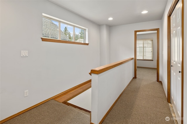 corridor with light colored carpet