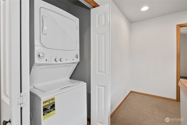 laundry room featuring light colored carpet and stacked washer and clothes dryer