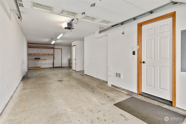 garage featuring electric panel and a garage door opener