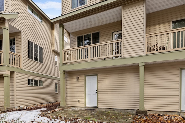 snow covered property featuring a balcony