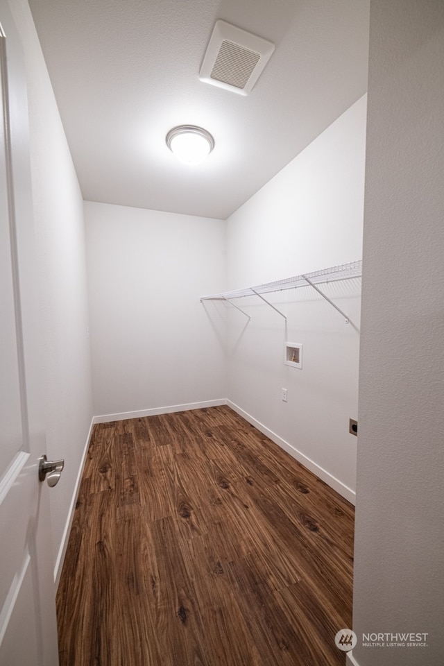 laundry area featuring washer hookup and dark hardwood / wood-style flooring