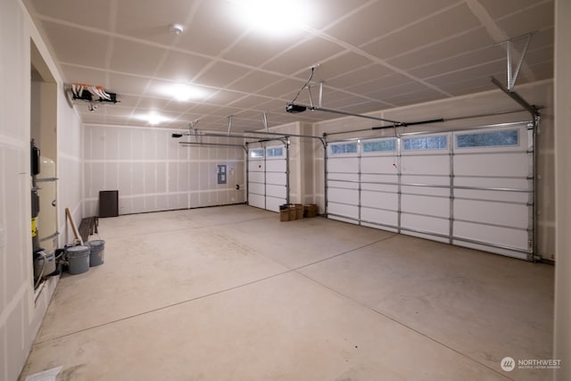 garage featuring electric panel and a garage door opener