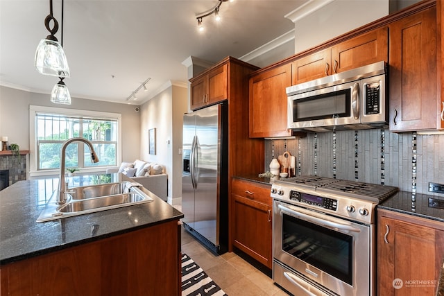 kitchen with sink, rail lighting, backsplash, light tile patterned floors, and appliances with stainless steel finishes