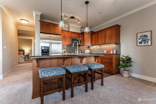 kitchen with stainless steel appliances, a kitchen breakfast bar, backsplash, crown molding, and light carpet