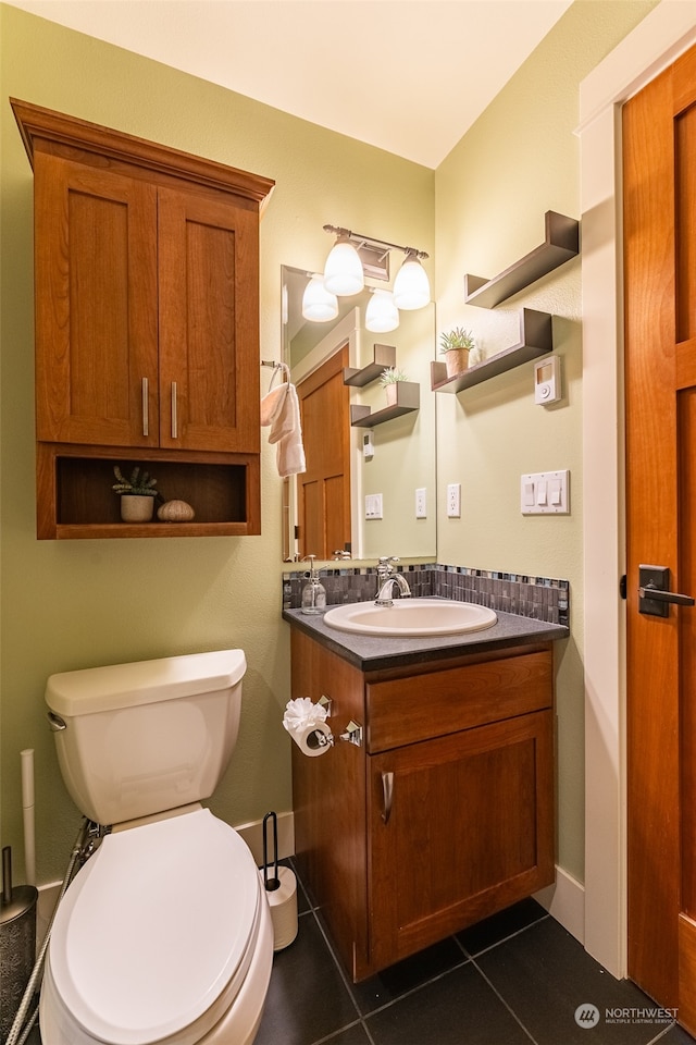 bathroom featuring tile patterned floors, vanity, and toilet