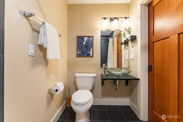 bathroom with tile patterned floors, sink, and toilet