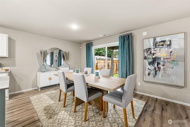 dining space with hardwood / wood-style floors