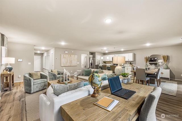 dining area with recessed lighting, wood finished floors, and baseboards