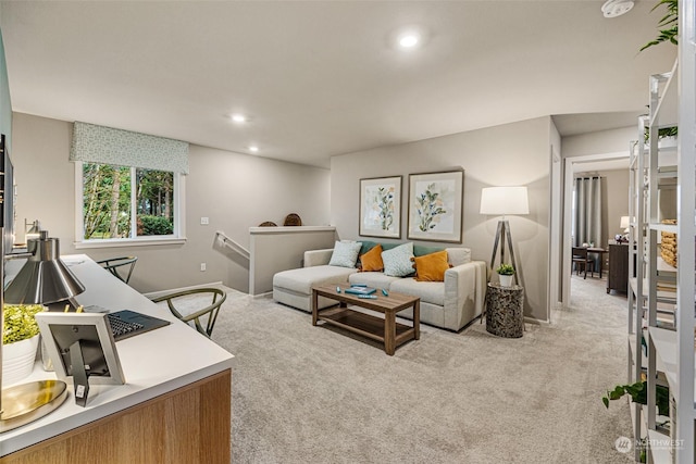 living room with recessed lighting, baseboards, and light carpet