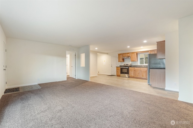 unfurnished living room featuring light carpet