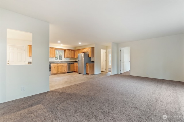 unfurnished living room featuring light colored carpet