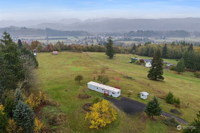 birds eye view of property with a mountain view and a rural view