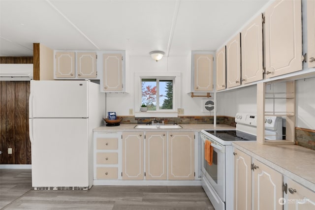 kitchen featuring sink, white cabinets, and white appliances