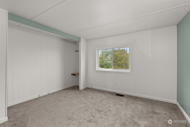 unfurnished room with light colored carpet