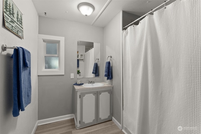 bathroom featuring hardwood / wood-style floors, vanity, and a shower with curtain