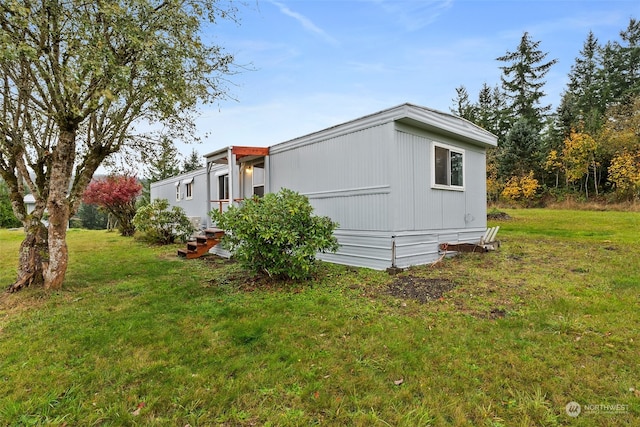 view of side of property with a yard