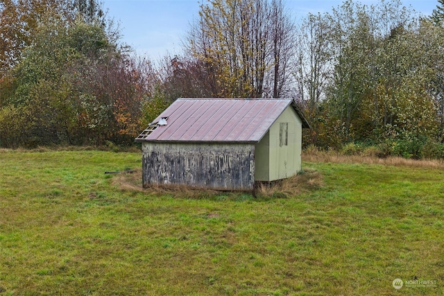 view of outdoor structure featuring a lawn