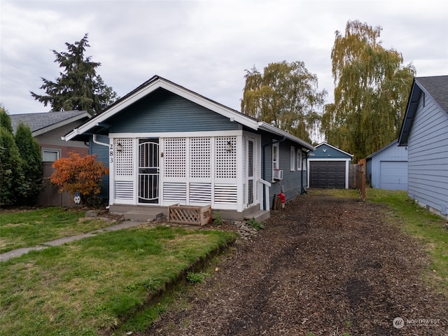 back of property featuring a lawn, cooling unit, an outdoor structure, and a garage