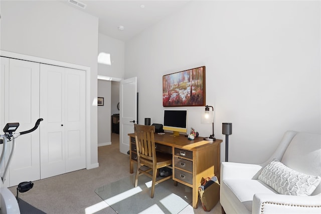 home office featuring carpet floors and a high ceiling