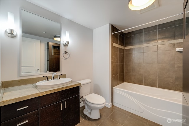 full bathroom with tile patterned flooring, vanity, toilet, and tiled shower / bath