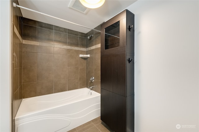 bathroom featuring tile patterned flooring and tiled shower / bath combo