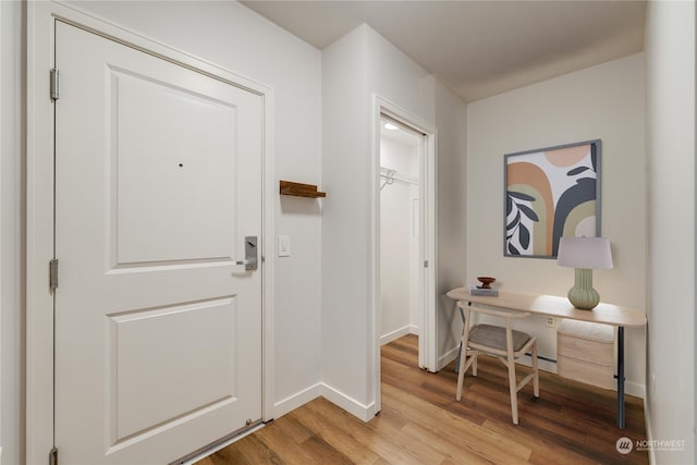 foyer entrance with light hardwood / wood-style floors