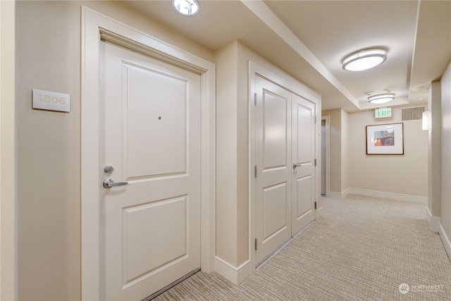 hallway with light colored carpet