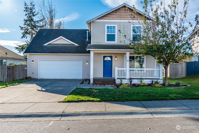 view of front of property featuring covered porch, a garage, and a front lawn