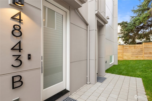 doorway to property with fence