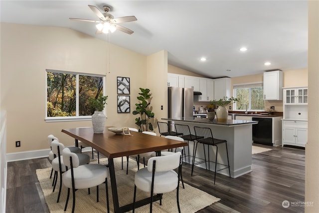 dining space with dark hardwood / wood-style floors, vaulted ceiling, ceiling fan, and sink