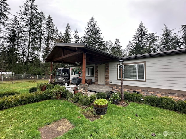 exterior space featuring a carport and a front lawn