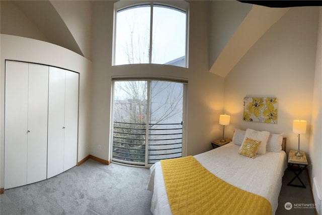 4333 9th Ave NE Unit C, Seattle, WA 98105 - bedroom featuring multiple windows, a closet, carpet floors, and a high ceiling