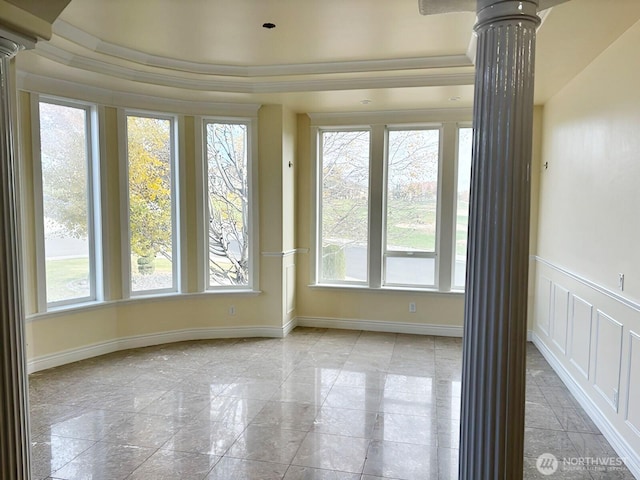 unfurnished sunroom with decorative columns and plenty of natural light