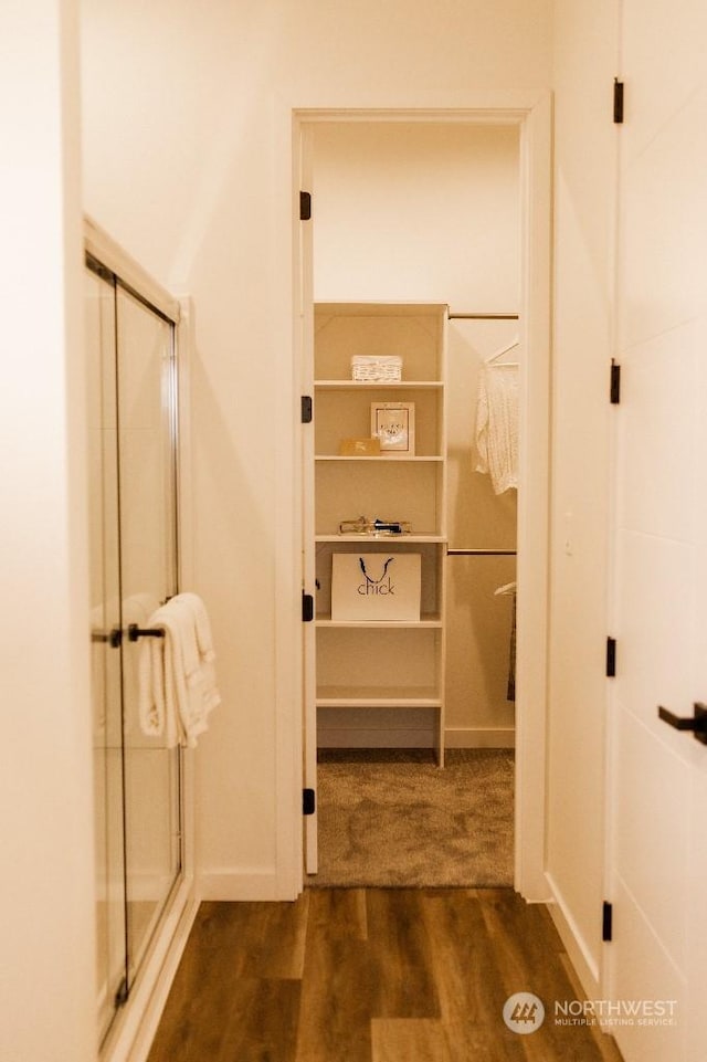 bathroom with hardwood / wood-style floors and walk in shower