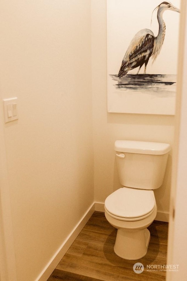 bathroom with hardwood / wood-style floors and toilet