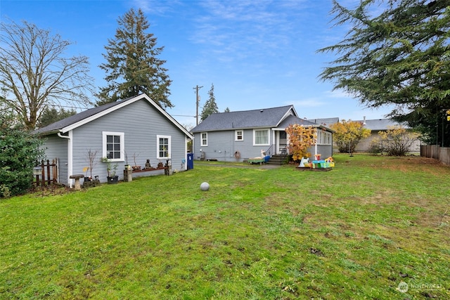 rear view of house with a lawn