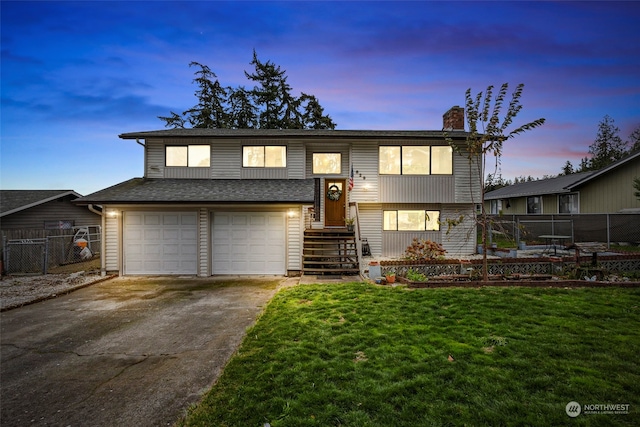 view of front of home featuring a yard and a garage