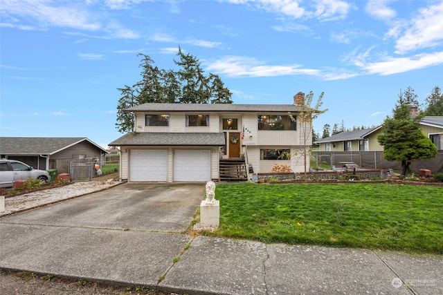 bi-level home featuring a garage and a front yard