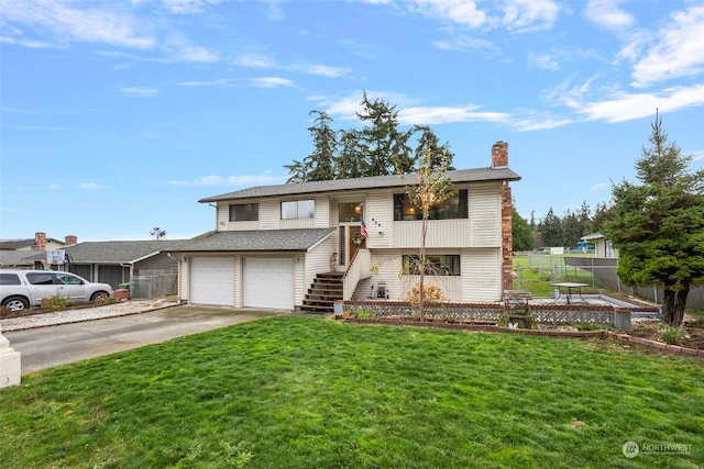 bi-level home with a front yard and a garage