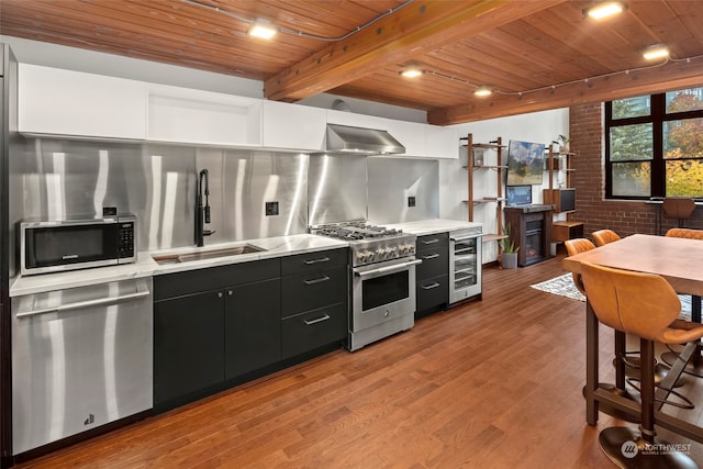 kitchen featuring sink, wooden ceiling, beverage cooler, stainless steel appliances, and light hardwood / wood-style floors