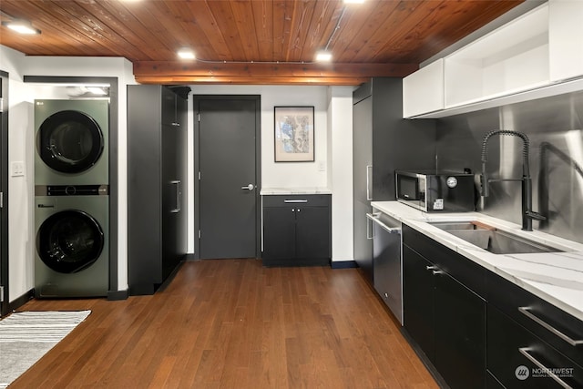 kitchen featuring appliances with stainless steel finishes, dark hardwood / wood-style flooring, sink, wooden ceiling, and stacked washer / drying machine