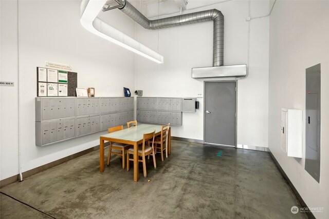 dining room with a mail area and a towering ceiling