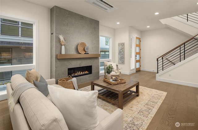 living room featuring a fireplace and wood-type flooring