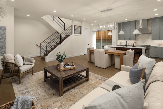 living room with light hardwood / wood-style floors and sink